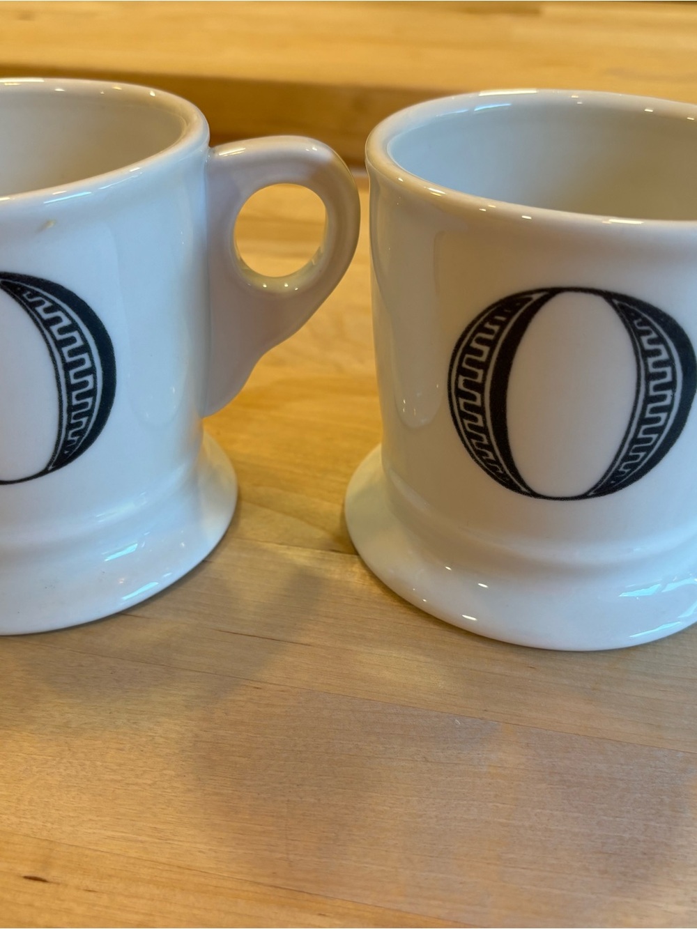 White Ceramic Coffee Mugs with Black Decorative Emblem - Set of 2